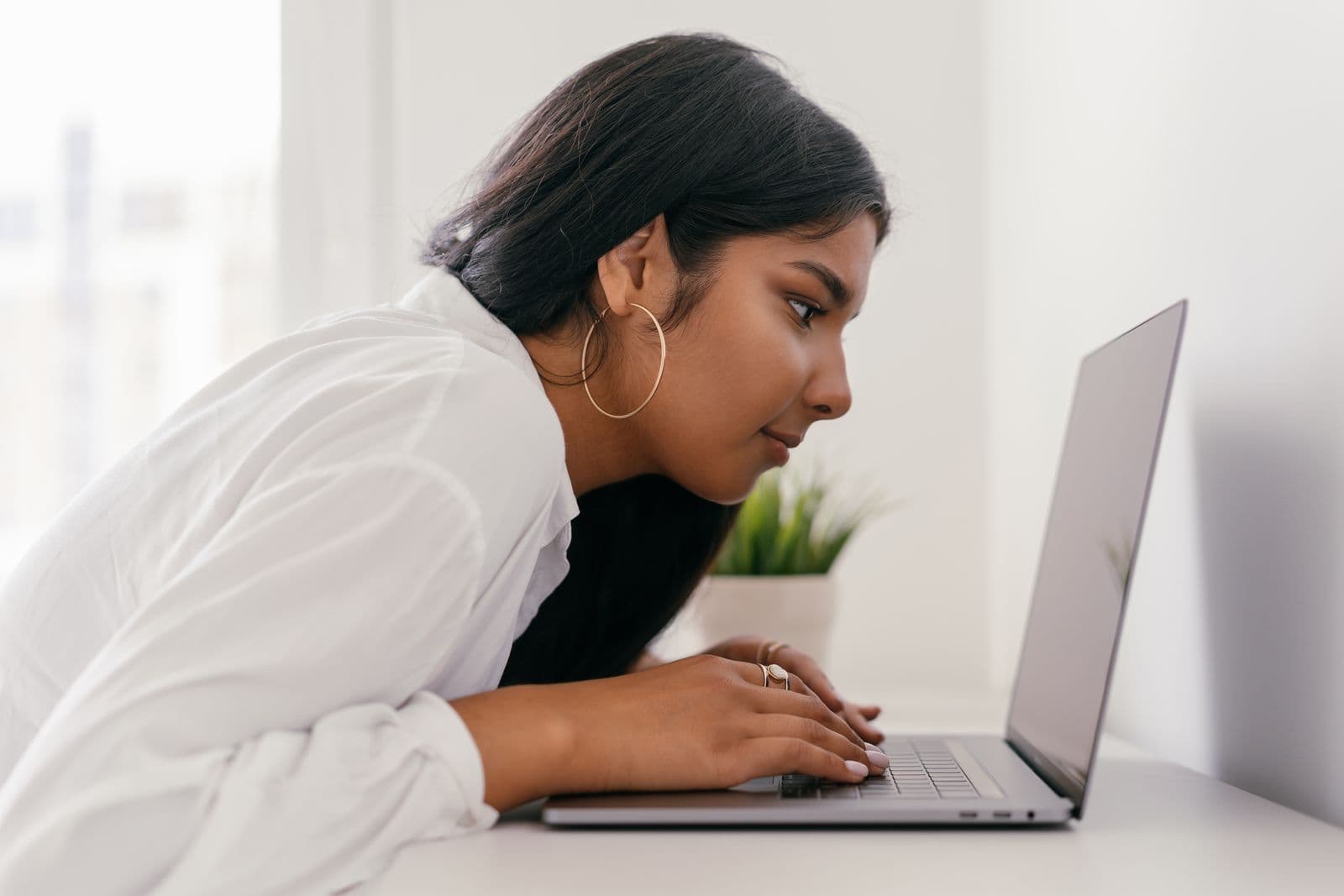 A student concentrating on her work at a laptop